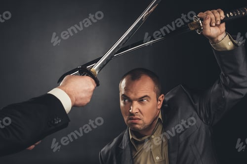 Preview: cropped shot of modern samurai fighting with swords on black