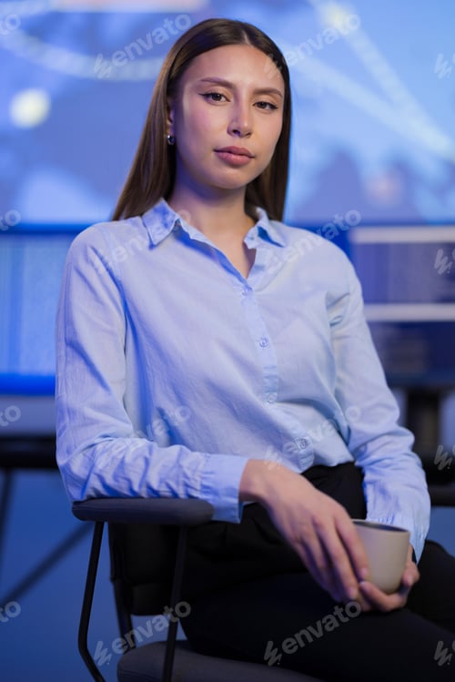 Preview: Confident professional woman working in modern technology environment analyzing data