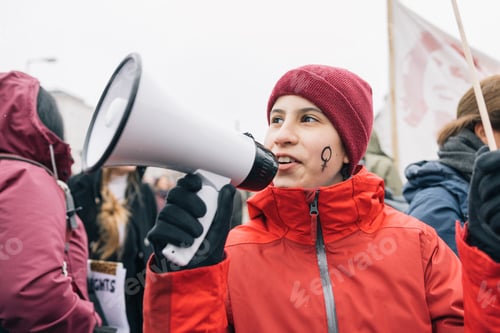 Preview: Teenage girl with a megaphone on international women's day on the streets of Berlin