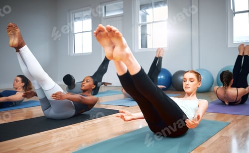Preview: Just a few more seconds. Shot of a group of students performing crunches during a pilates class.