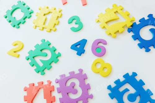 Preview: Colorful bright puzzle numbers on white background, education concept