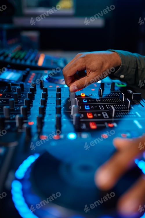 Preview: Closeup male hand on sound mixer console