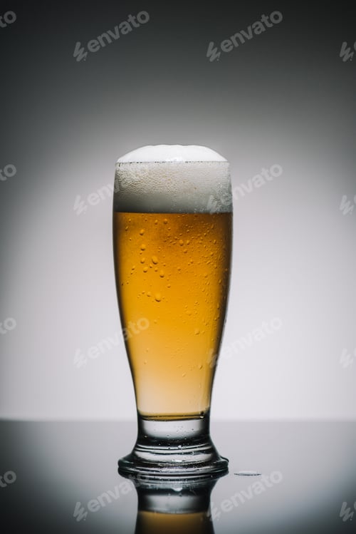 Preview: full glass of beer with foam on table