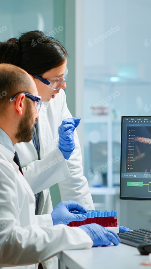 Preview: Team medical scientist conducting DNA experiments looking in computer