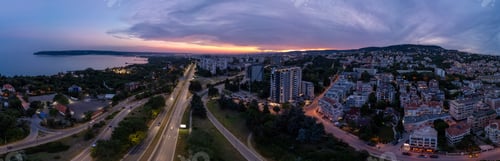 Preview: Aerial panoramic view of Varna, Bulgaria at sunset. Urban landscape with coastal city lights, reside