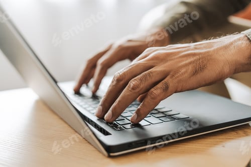 Preview: Close up of freelancer working on laptop, copywriter typing on keyboard selective focus on hands