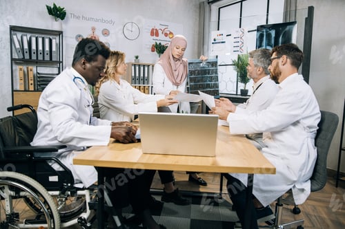 Preview: Multiethnic group of doctors having conference at office