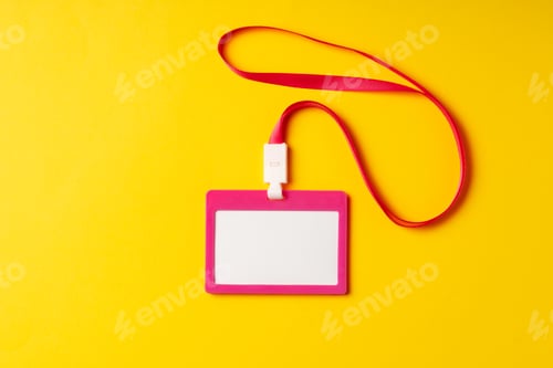 Preview: Blank nametag on a string on yellow background copy space