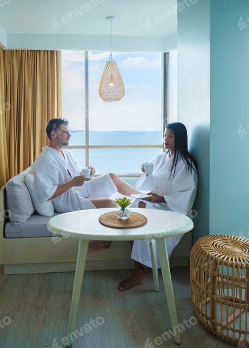 Preview: Couple of Asian women and caucasian men drinking coffee in hotel in Thailand