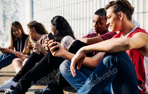 Preview: Group of young teenager friends chilling out together using smartphone social media concept