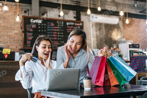 Preview: Young women enjoy shopping with credit cards.