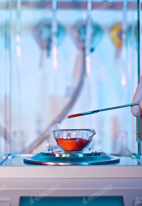 Preview: A scientist pipetting a red solution into a petri dish in a laboratory