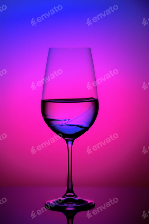 Preview: Crystal clear glass of liquid against a vibrant, neon pink background