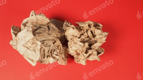 Preview: Crumpled brown paper.It is mauled on red background.