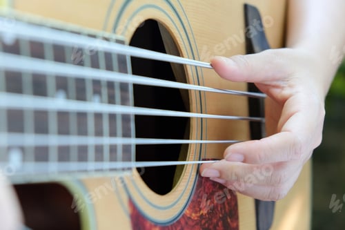 Preview: close up of 5 string acoustic bass guitar.