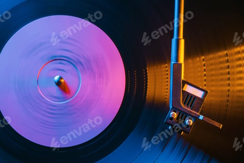 Preview: Movie of retro-styled record player spinning vinyl black record.Cinemagraph.Side view.Beautiful neon