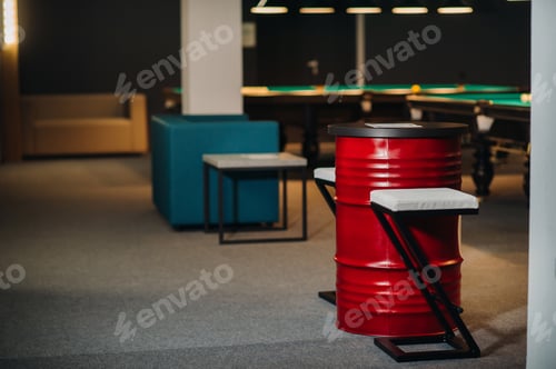 Preview: table and two chairs near the green-covered billiard table with balls in the billiard club