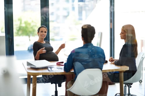 Preview: Shot of a pregnant businesswoman having a meeting with colleagues in office