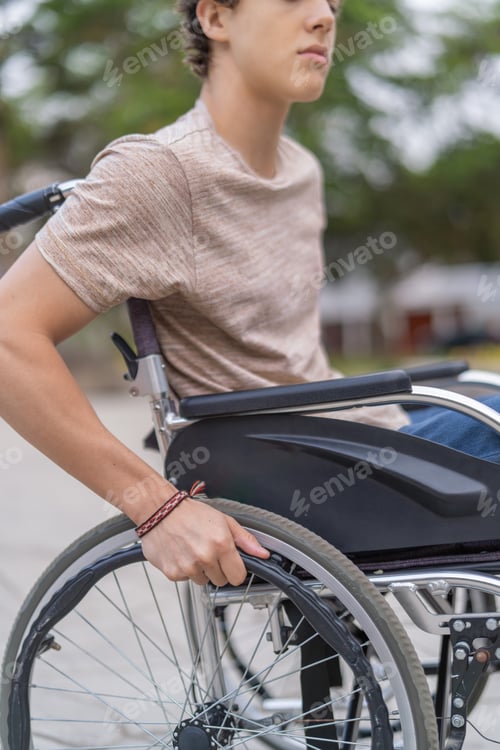 Preview: Strong young handicapped man pushing his wheelchair