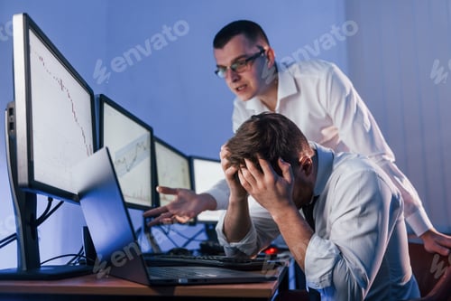 Preview: Bad luck, failure. Two stock traders working in the office with exchange technology