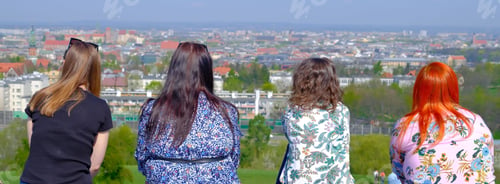 Preview: Four women look at the city skyline.