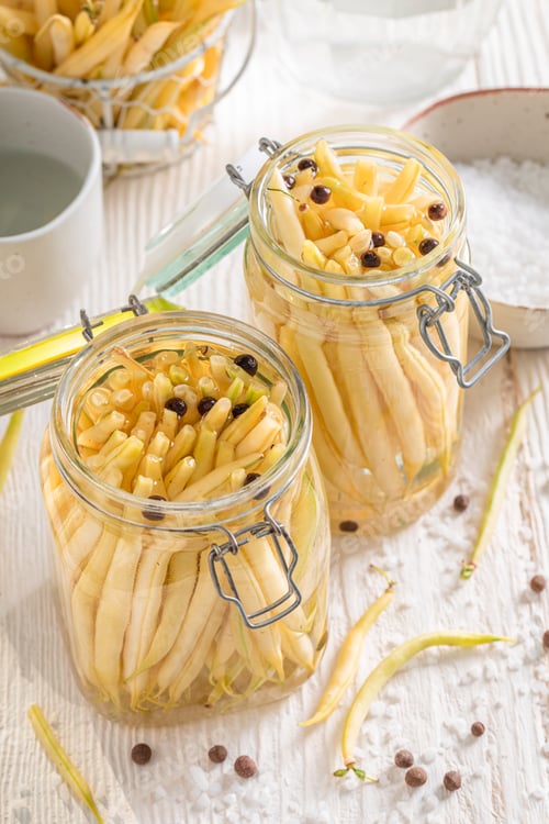 Preview: Healthy pickled yellow beans in jar with herbs.