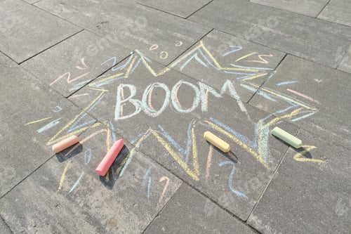 Preview: Text Boom drawing crayons on gray asphalt