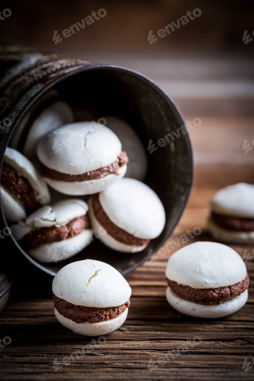 Preview: Homemade macaroons with nut filling on old wooden table