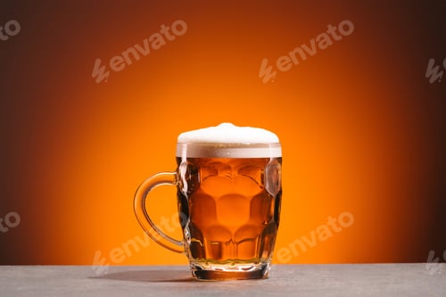 Preview: close up view of mug of cold beer on orange backdrop