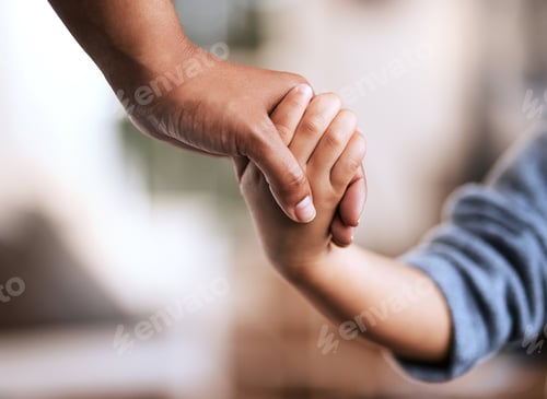 Preview: Your hand is safe in mine. Shot of an unrecognizable parent and child holding hands at home.