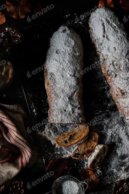 Preview: Pieces of Stollen near sieve and autumn leaves