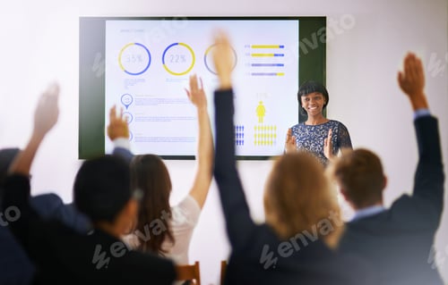 Preview: Workshop in progress. Shot of a group of people raising their hands in a class.