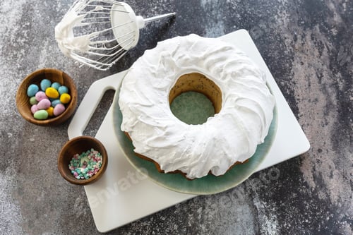 Preview: Cooking Glazed easter lemon cake decorated with confectionery and mini chocolate eggs candy.