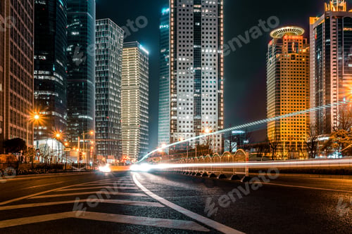 Cityscape at Night with Light Streaks on Street