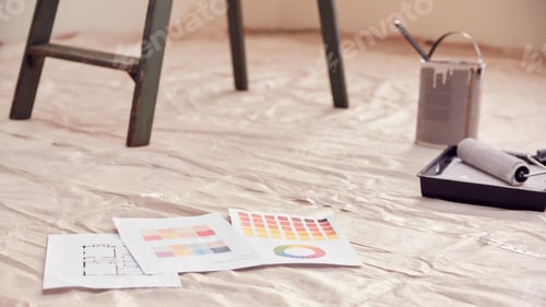Preview: Close Up Of Color Charts With Paint Roller And Step Ladder In Room Being Decorated