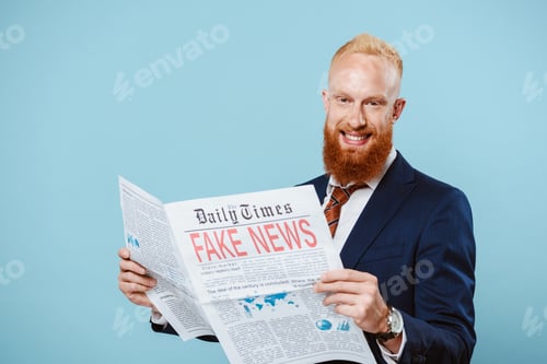 Preview: smiling bearded businessman reading newspaper with fake news, isolated on blue