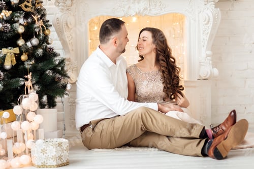 Preview: Loving Couple Cuddling By Christmas Tree Indoors