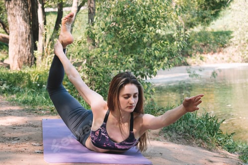 Preview: The girl practicing yoga in nature.The concept of a sports healthy lifestyle.