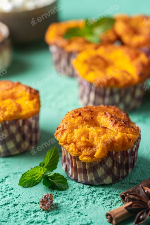 Preview: Sweet homemade cottage cheese muffins with pumpkin on blue background