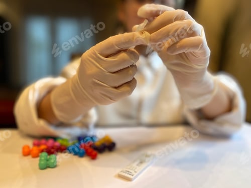 Preview: Person Wearing Gloves Holding a Medical Swab