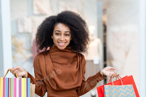 Preview: Portrait of a joyful woman shopper, walks through a supermarket in a large store with clothes