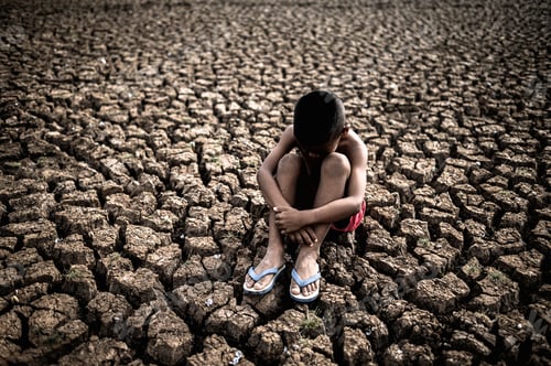 Preview: Men sitting hugging their knees, bent, bent on the dry soil,global warming