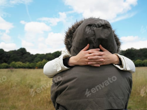 Preview: Couple in parkas hugging