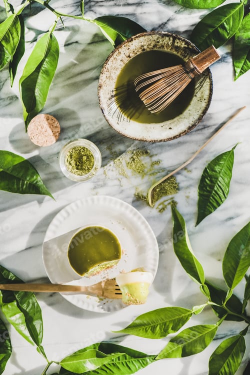 Preview: Flat-lay of green matcha cheesecake dessert and matcha powder