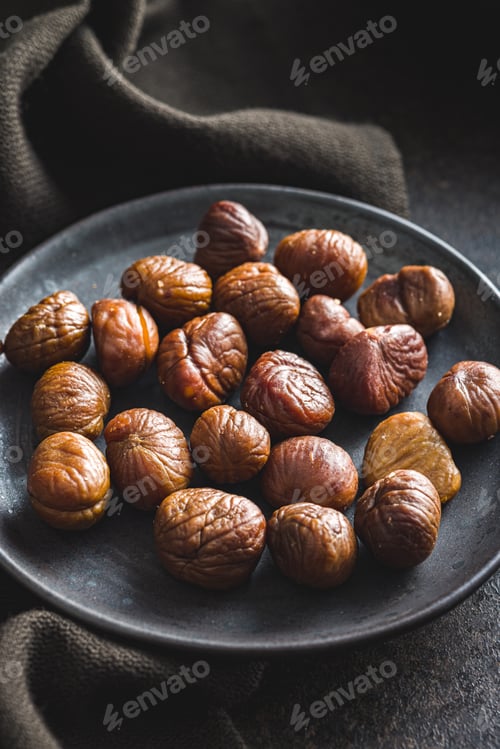 Preview: Peeled chestnuts. Sweet roasted chestnuts on plate.