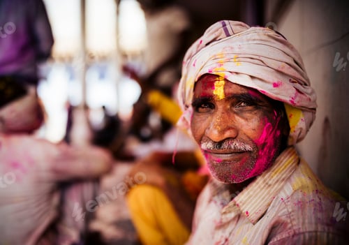 Preview: Man with a colorful face celebrating Holi