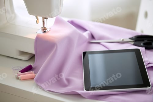 Preview: sewing machine, tablet pc, fabric and threads