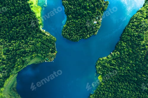 Preview: Aerial View of Lush Green Forests Surrounding Serene Blue Water Body in Nature's Embrace