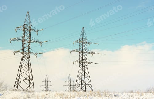 Preview: Towers of power lines in the winter field. Electrical equipment