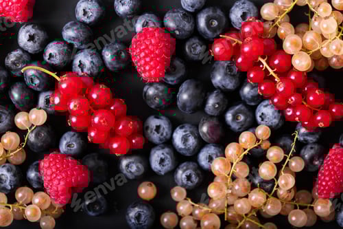 Preview: Fresh summer berries in vintage mug over black background, top view
